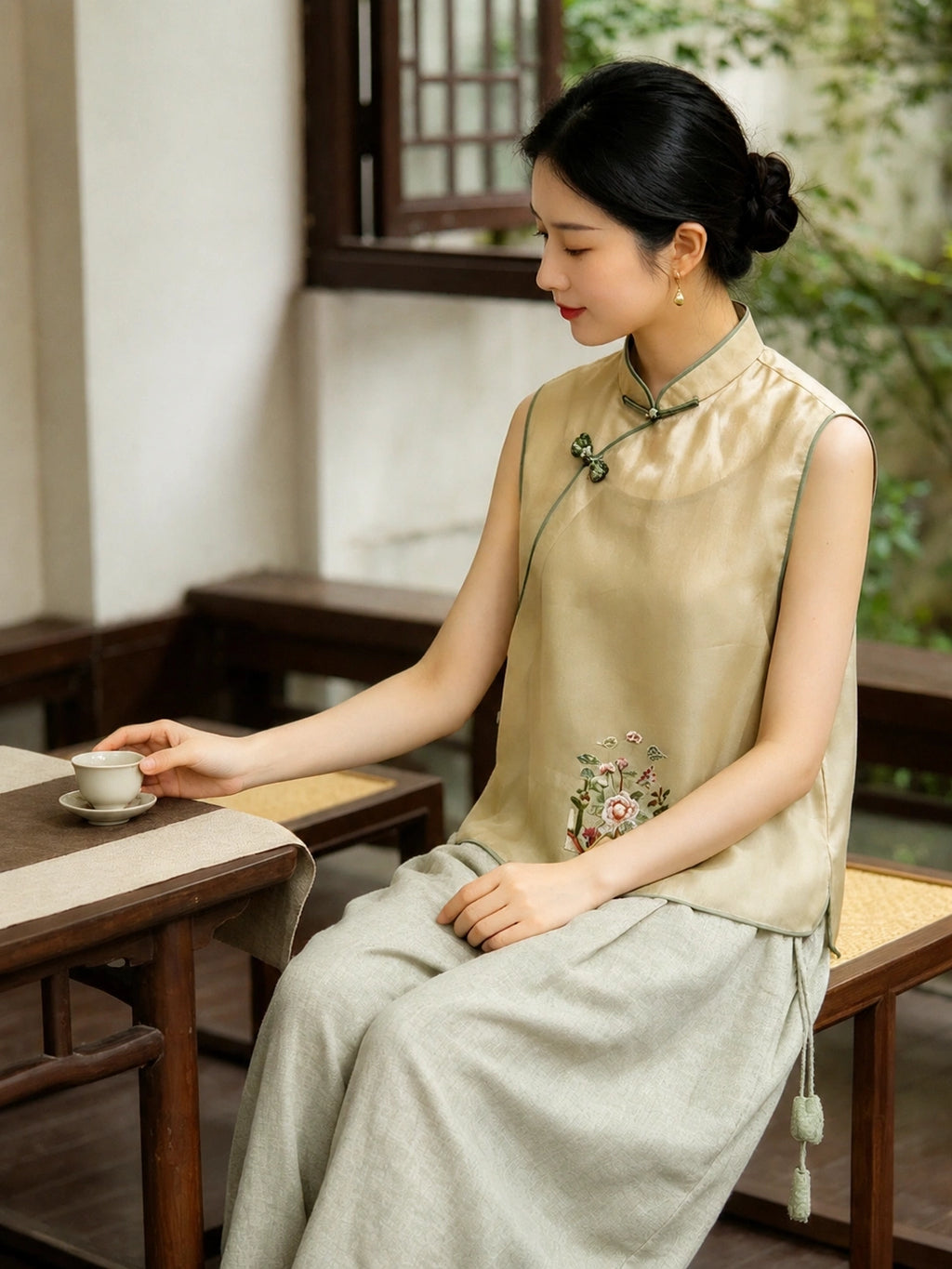 Golden yellow mulberry silk vest with hand-knotted frog closures styled with wide-leg pants