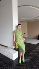 Side view of a green sleeveless Qipao dress with a mandarin collar and side slits, showcasing the breathable Lyocell-linen blend.