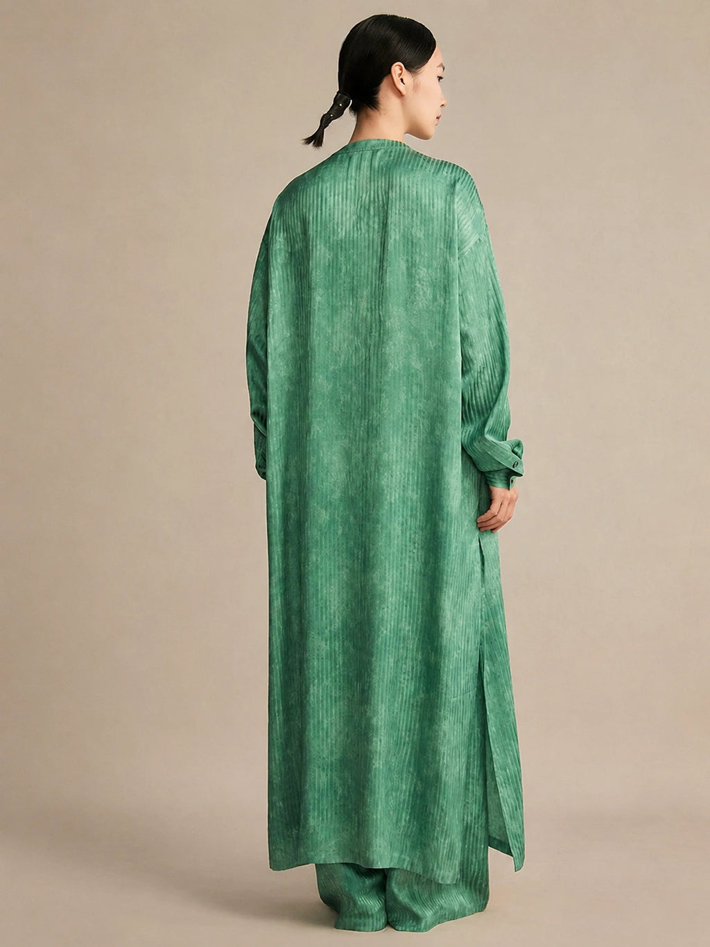 Back view of the silk tunic demonstrating the straight, fluid drape and high side slits that create a relaxed, elegant, and effortlessly chic silhouette.
