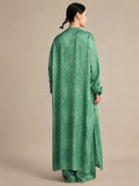 Back view of the silk tunic demonstrating the straight, fluid drape and high side slits that create a relaxed, elegant, and effortlessly chic silhouette.