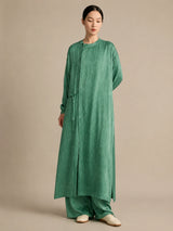 Another front view of the green silk tunic featuring a side tie for adjustable fit and a beautifully textured crinkled silk finish.