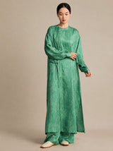 Model wearing a light green 100% mulberry silk crinkled tunic, showcasing the relaxed, comfortable silhouette and natural drape from the front.