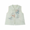 Flat lay of a light green sleeveless vest with a Peter Pan collar, intricate floral embroidery, and a front button placket.