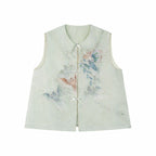 Flat lay of a light green sleeveless vest with a Peter Pan collar, intricate floral embroidery, and a front button placket.