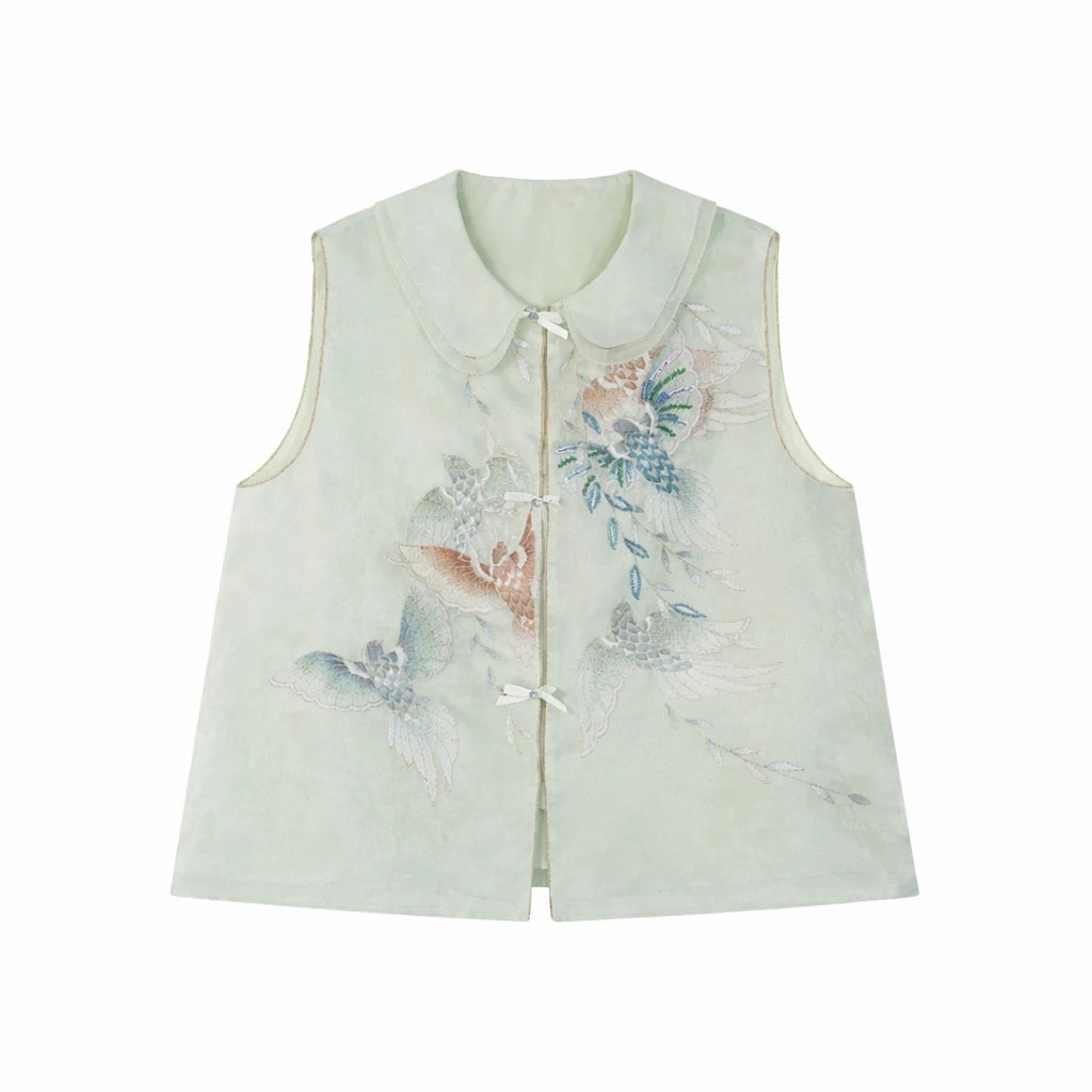 Flat lay of a light green sleeveless vest with a Peter Pan collar, intricate floral embroidery, and a front button placket.