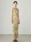Side angle of women's floral sleeveless maxi dress in cupro blend fabric.