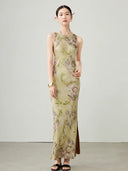 Model walking in a green floral sleeveless maxi dress with a flowing silhouette.