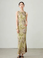 Model walking in a green floral sleeveless maxi dress with a flowing silhouette.