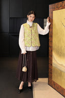 Full-length outfit featuring the green silk vest, white blouse and dark brown skirt