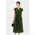 Full body shot of a green silk A-line midi dress with short sleeves, a tied waist, and embroidered floral pattern, crafted from 100% mulberry silk, perfect for elegant daily wear.