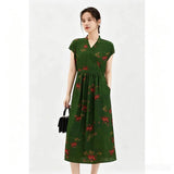 Full body shot of a green silk A-line midi dress with short sleeves, a tied waist, and embroidered floral pattern, crafted from 100% mulberry silk, perfect for elegant daily wear.