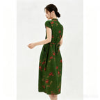 Side view of a forest green silk Cheongsam dress with a wrap-style V-neckline, red floral embroidery, and a tied waist, crafted from 100% mulberry silk, midi length with side pockets.