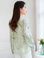 Back view of a light green 100% mulberry silk open-front shirt with a relaxed fit and flowing drape, showcasing the delicate watercolor landscape print.
