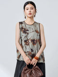 Front view of a grey 100% mulberry silk tank top with a round neckline and brown trim, featuring a relaxed fit and abstract ink wash print.