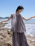 Grey ramie lyocell top and maxi skirt set styled for a coastal summer look.