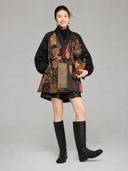 Front view of a women’s mid-length Gambiered Silk down coat featuring bronze, red and teal patchwork-style patterns.