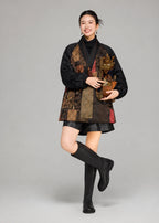 Full-length styling view of the loose black silk goose down coat with patterned front panels and balloon sleeves.