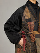 Detail view of the black quilted sleeve, patterned silk panels and adjustable waist tie.