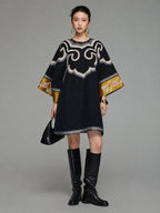 Model wearing a heritage-inspired navy silk tunic dress with round neckline and embroidered wide sleeves