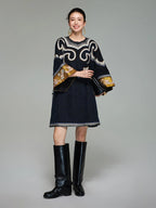 Front view of a woman wearing the midnight navy Xiangyunsha silk tunic dress with embroidered scroll motifs and golden cuffs