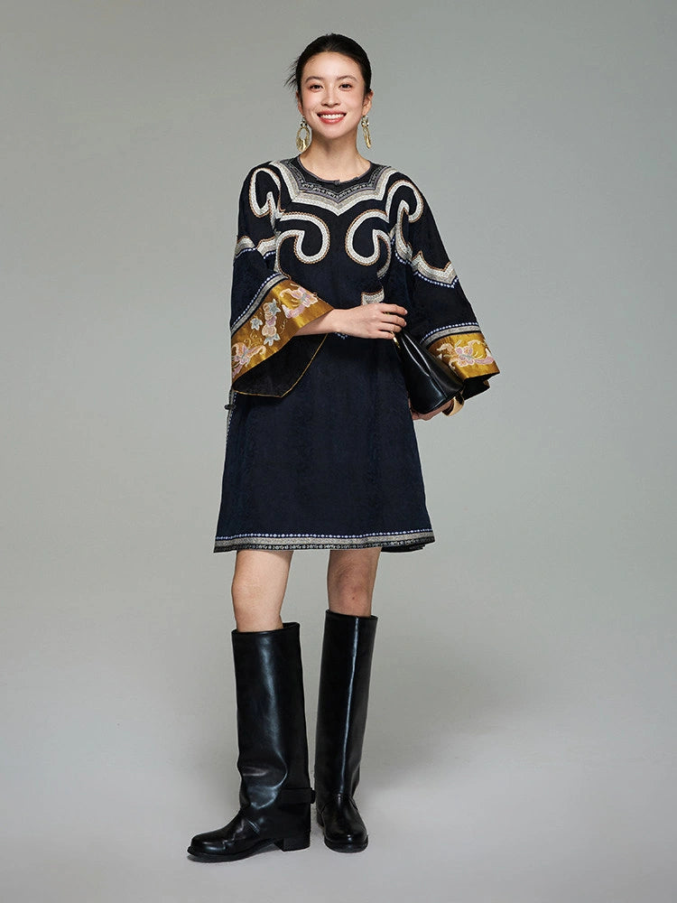 Front view of a woman wearing the midnight navy Xiangyunsha silk tunic dress with embroidered scroll motifs and golden cuffs