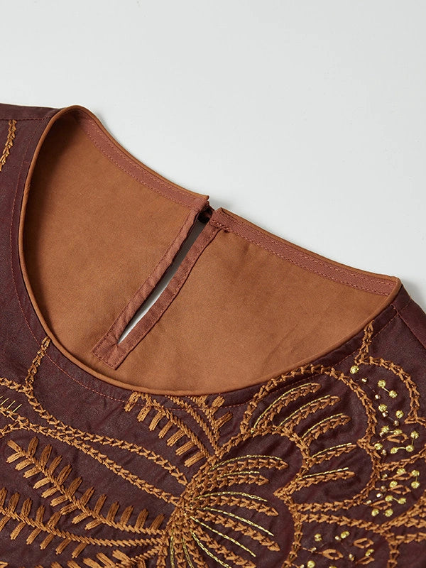 Close-up of the round neckline, back keyhole and amber botanical embroidery on red Hongyunsha silk