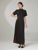 Elegant woman wearing an ink black 100% mulberry silk jacquard cheongsam maxi dress with a mandarin collar.