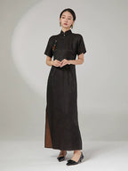 Full-length ink black silk cheongsam dress with subtle jacquard texture and side slit for graceful movement.