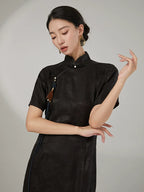 Detail view of the luxurious mulberry silk jacquard texture and refined Oriental-inspired craftsmanship of the dress.