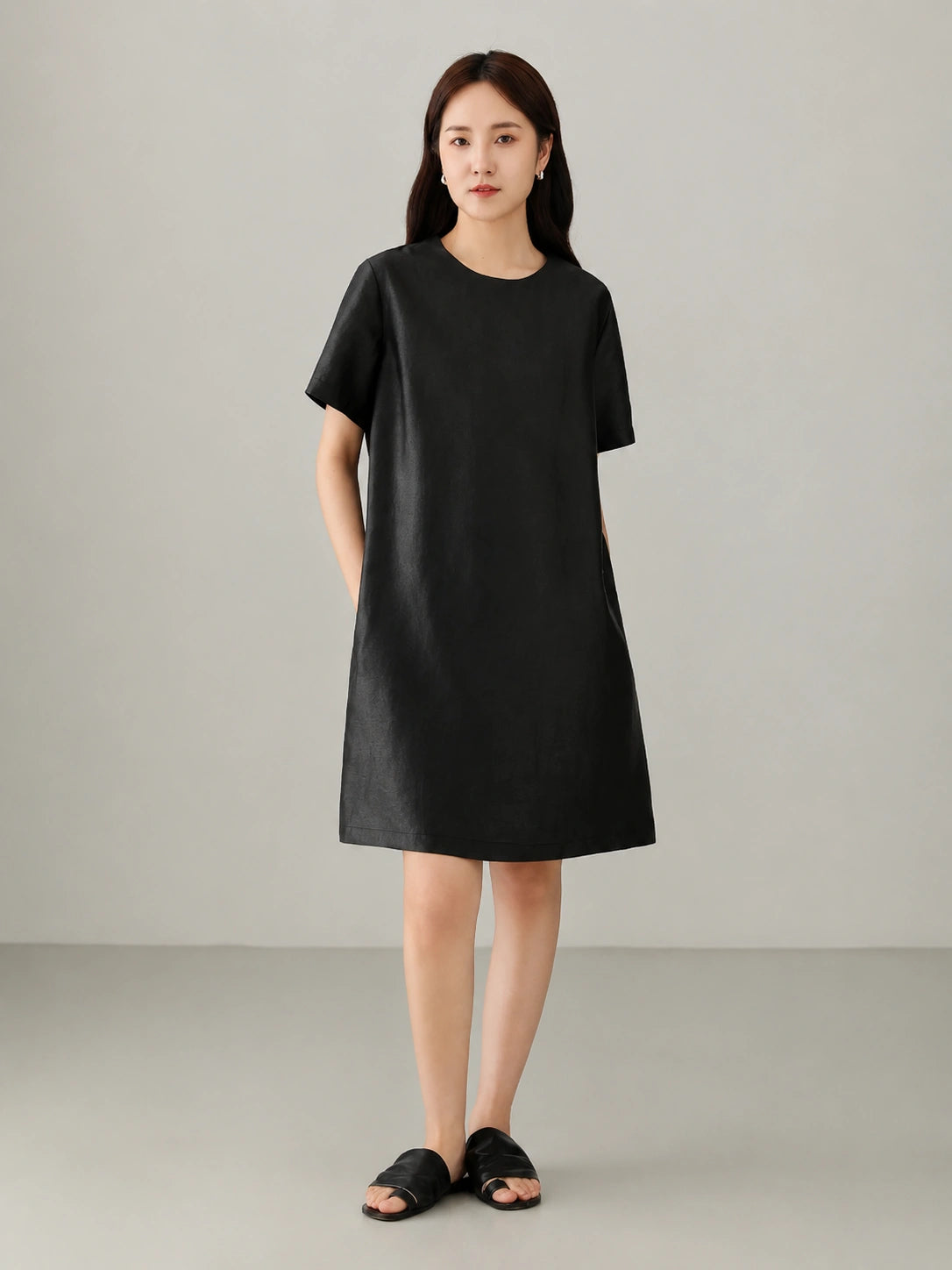 Close view of burgundy red Xiangyunsha mulberry silk dress showing smooth matte texture and minimalist oriental design details