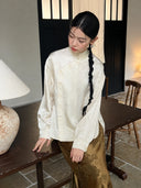Model wearing an ivory acetate Mandarin collar shirt with subtle lotus jacquard patterns