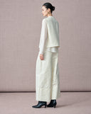 Back view of the ivory wool-silk vest styled with an ivory blouse and trousers