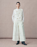 Front view of the ivory round-neck vest with embroidered butterfly details