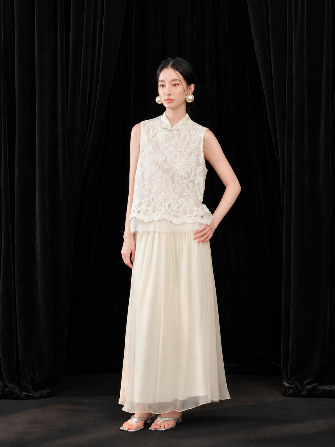 Front view of an ivory Chinese-style A-line skirt paired with a delicate embroidered organza top.