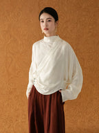 Woman wearing the Ivory Cross-Over Mandarin Collar Blouse by Gambiered Silk.