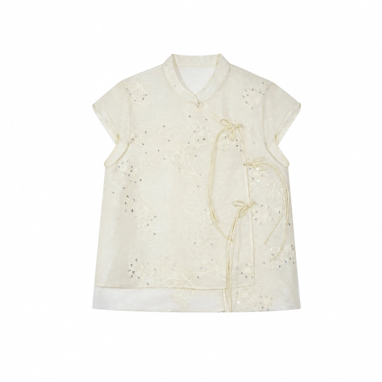 Flat lay of an ivory short-sleeve Cheongsam top with floral embroidery, sequins, and side tie details, crafted from a Lyocell-metallic blend.