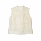 Flat lay of an ivory sleeveless embroidered vest with a mandarin collar, floral embroidery, and side tie details.