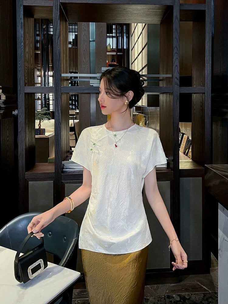 Front view of an ivory mulberry silk blend jacquard blouse featuring a classic round neckline.