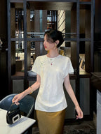Front view of an ivory mulberry silk blend jacquard blouse featuring a classic round neckline.