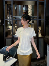 Front view of an ivory mulberry silk blend jacquard blouse featuring a classic round neckline.