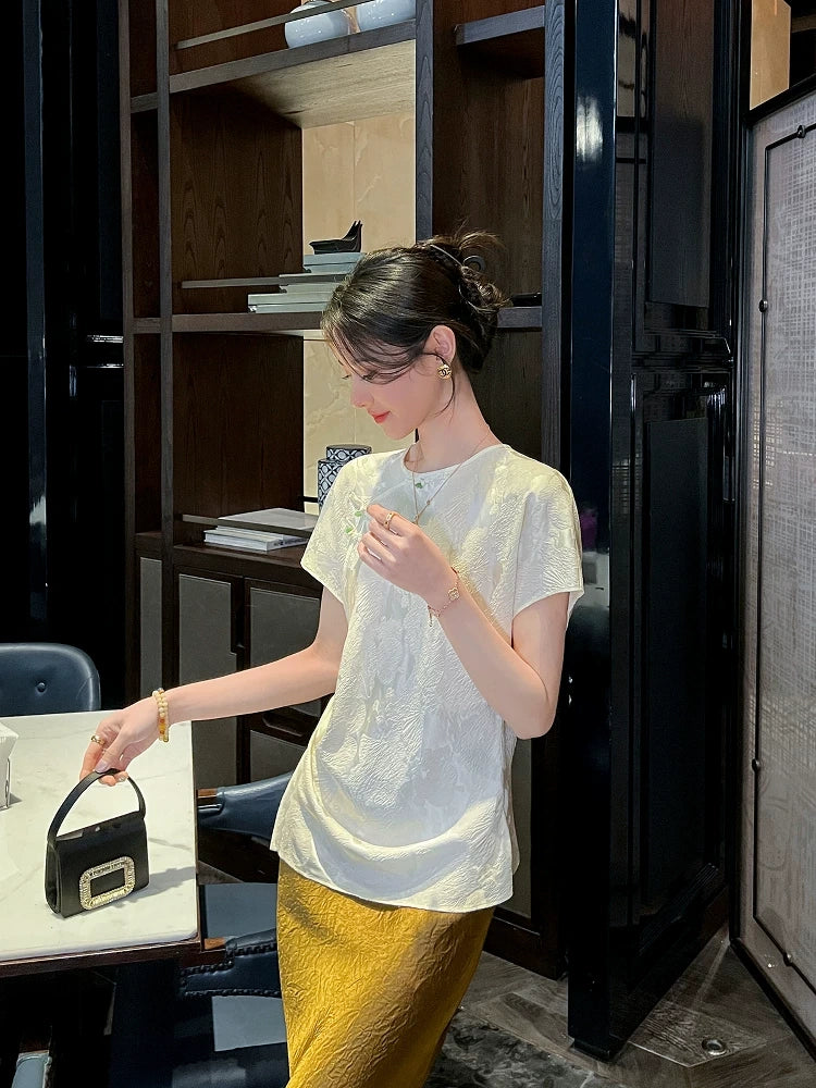 Women's ivory mulberry silk blend jacquard short sleeve blouse styled with a satin skirt.