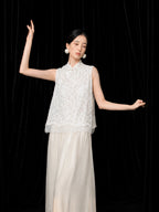 Model wearing an ivory high-waist A-line silk skirt with a flowing ankle-length silhouette.