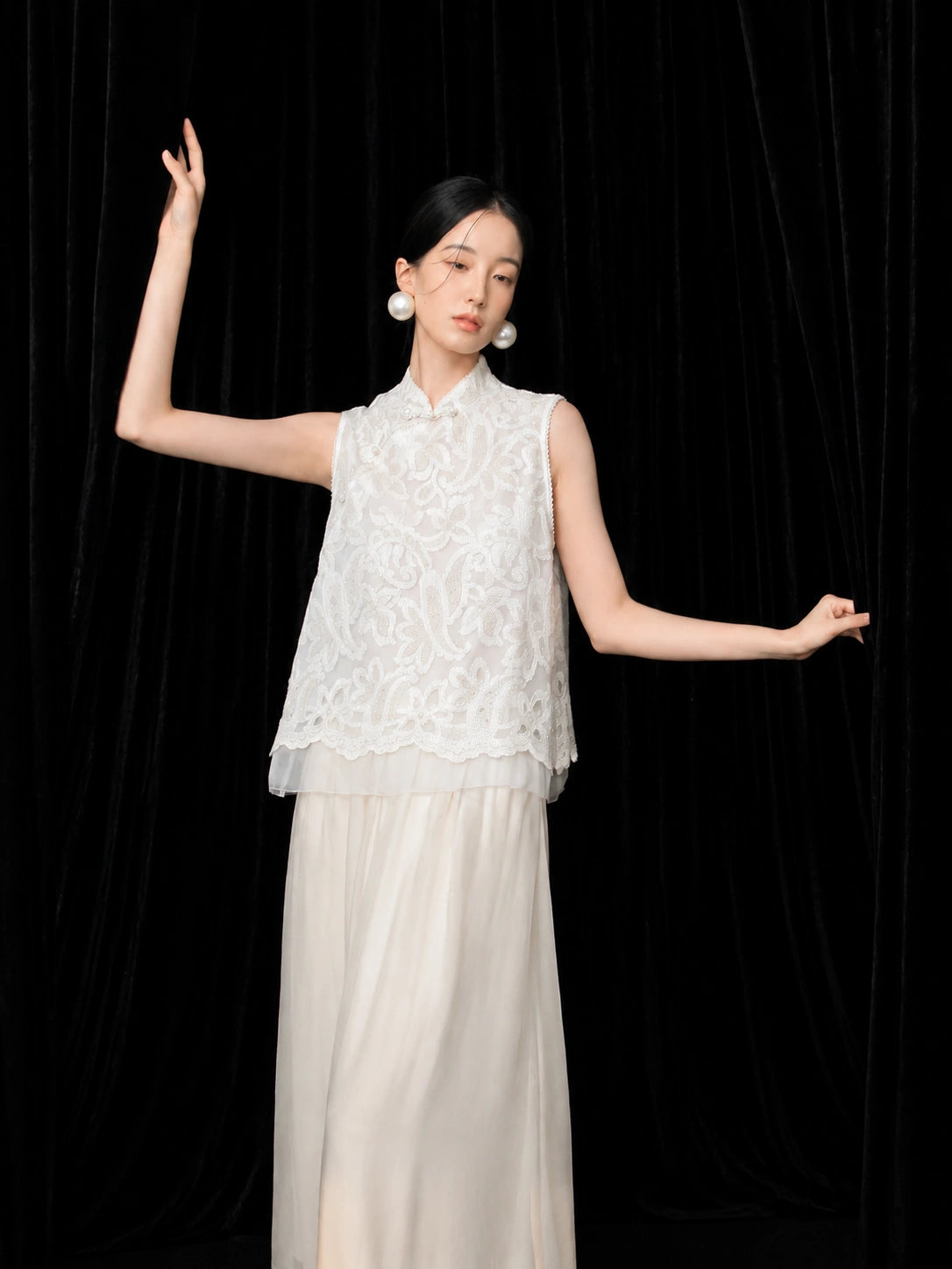 Model wearing an ivory high-waist A-line silk skirt with a flowing ankle-length silhouette.