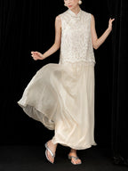 Close view of the flowing ivory silk skirt hem moving naturally as the model walks.