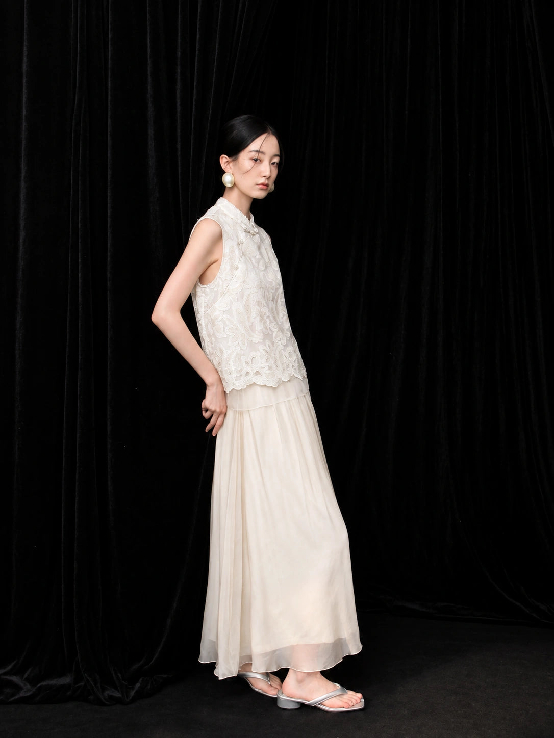 Side view of an ivory 100% mulberry silk skirt with a soft drape and fluid movement.