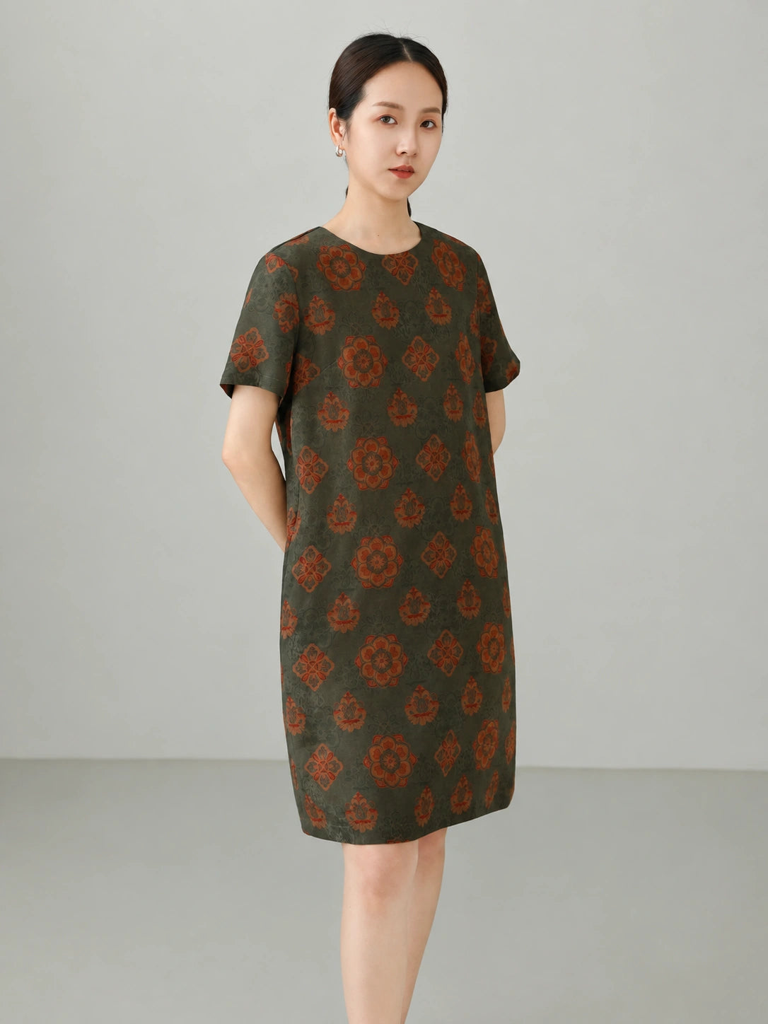 Side view of women's Xiangyunsha silk dress showing relaxed straight fit, lightweight drape, and traditional Chinese floral pattern.