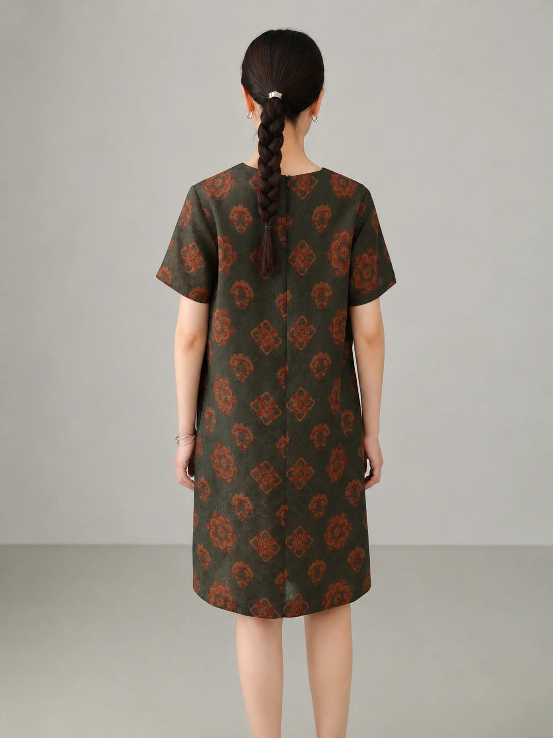 Back view of jade lotus pattern Xiangyunsha mulberry silk dress featuring traditional floral motifs and elegant straight silhouette.