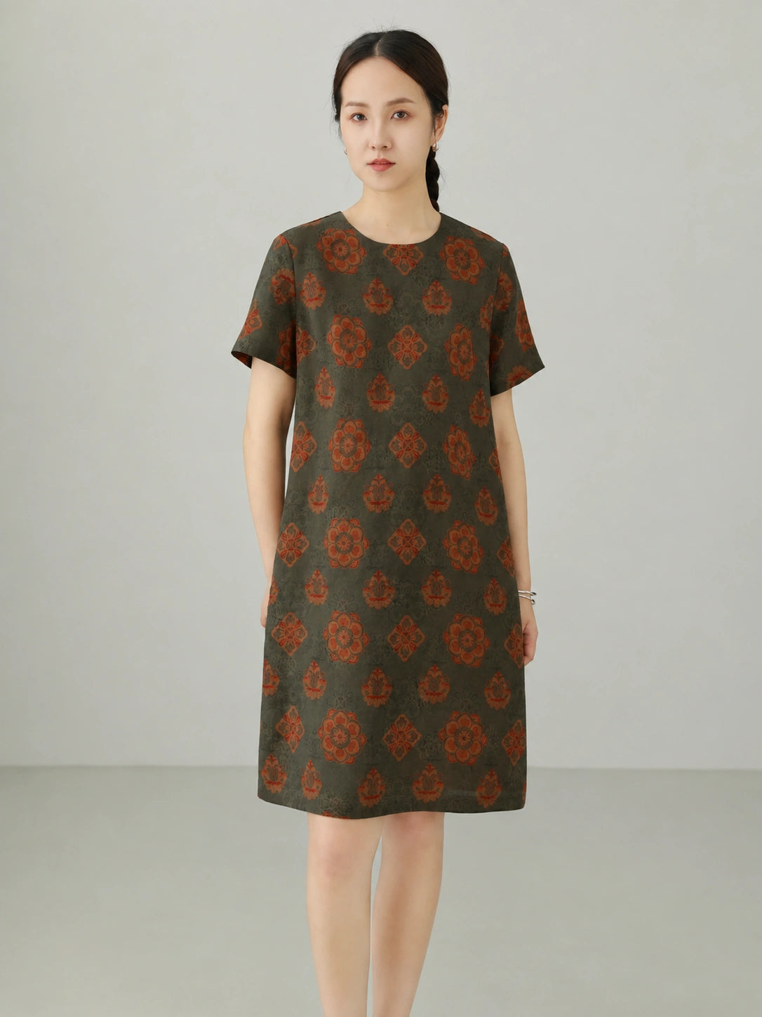 Front view of 100% mulberry silk Xiangyunsha dress with jade green floral pattern, round neckline, and minimalist oriental design.