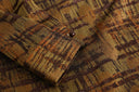 Close-up of the plaid sleeve cuff and its small dark button.