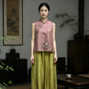 Front view of a jujube red Chinese-inspired silk vest with Suzhou floral embroidery and green piping